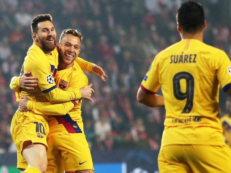 Barcelona's Lionel Messi (l) celebrates his goal at Slavia Prague with Arthur and Luis Suarez.