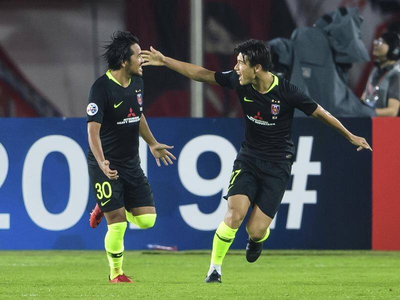 Shinzo Koroki, left, celebrates scoring for Urawa Red Diamonds against Guangzhou Evergrande.