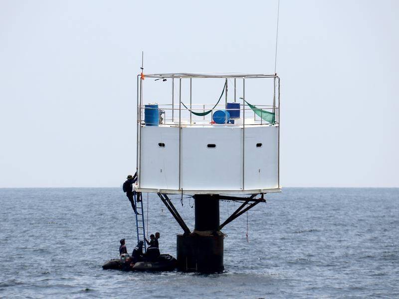 Thailand's navy have begun remove a "seasteading" floating home about 26km from Phuket.