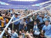 Manchester City fans celebrate retaining the Premier League title after a 3-2 win over Aston Villa.