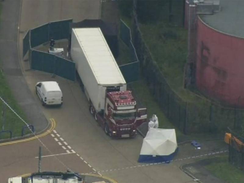 Forensic officers are at the scene where 39 bodies were found in a truck container east of London.