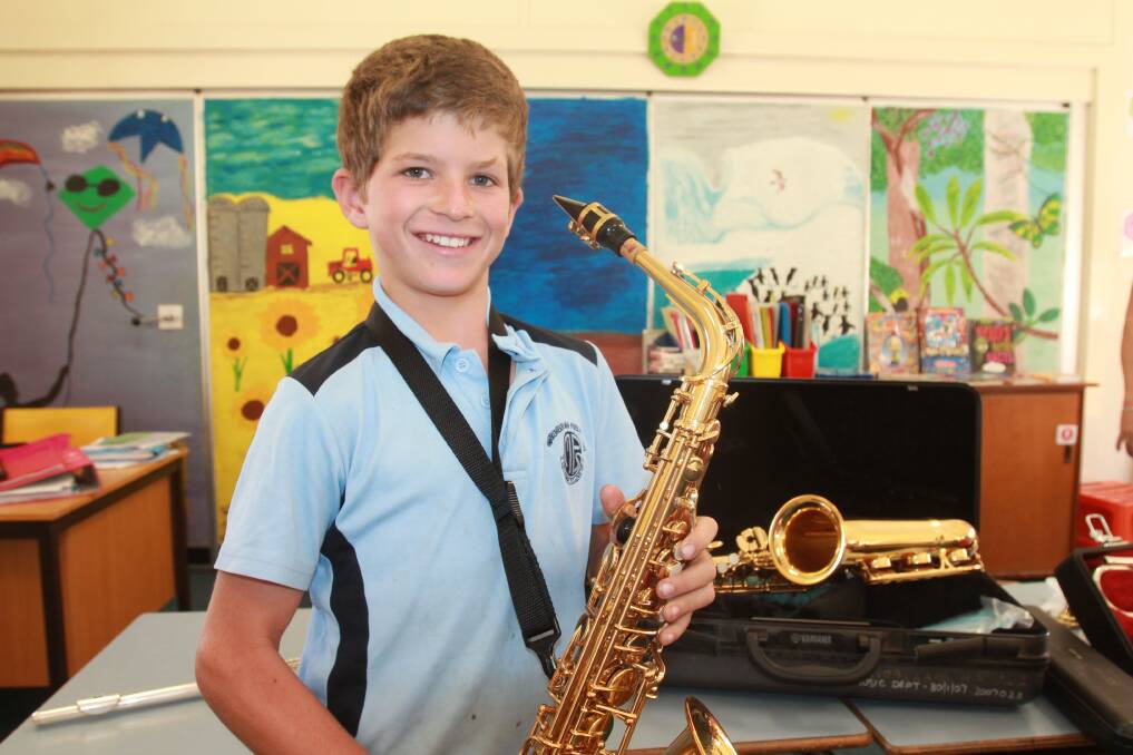 RIGHT NOTE: Charlie Lenehan gets comfortable with saxophone during try-outs for the Murrumburrah Public School band. Photo: Declan Rurenga